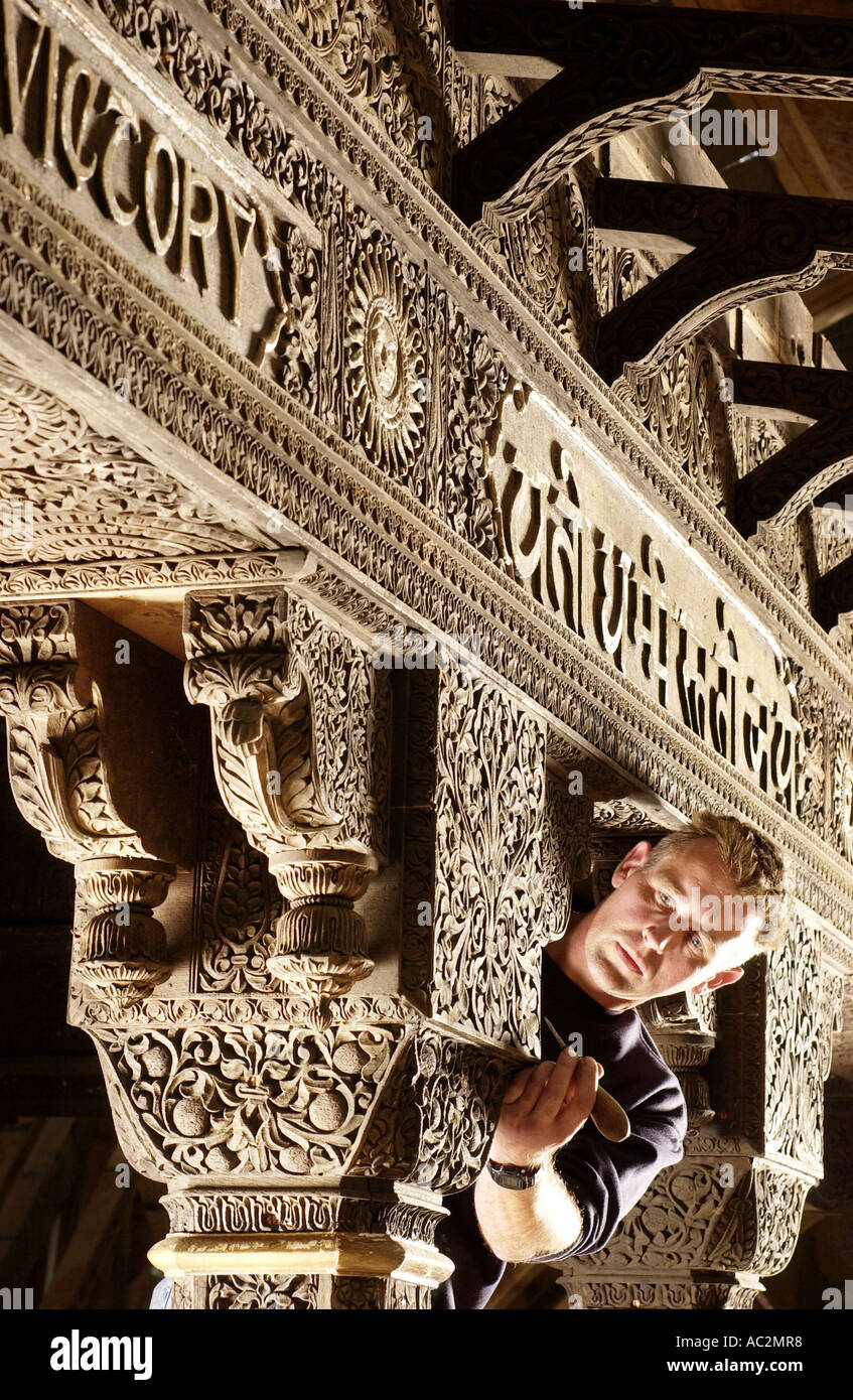 Skilled carpenter restoring an ornate Indian woodcarving in solid teak. Stock Photo