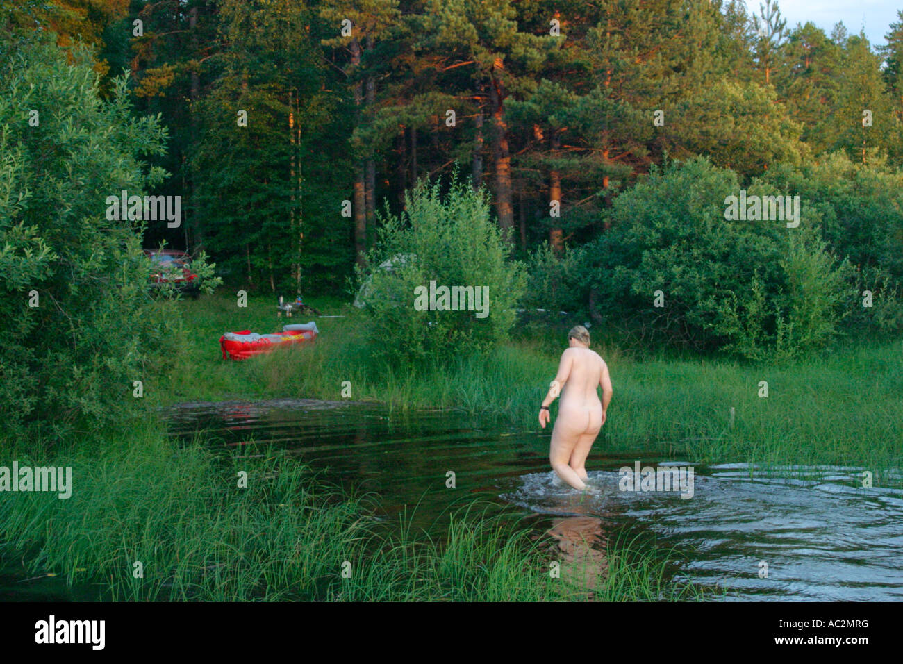 a young woman skinny-dipping in Lake Siljan in the area of Dalarna in the  South of Sweden Stock Photo - Alamy