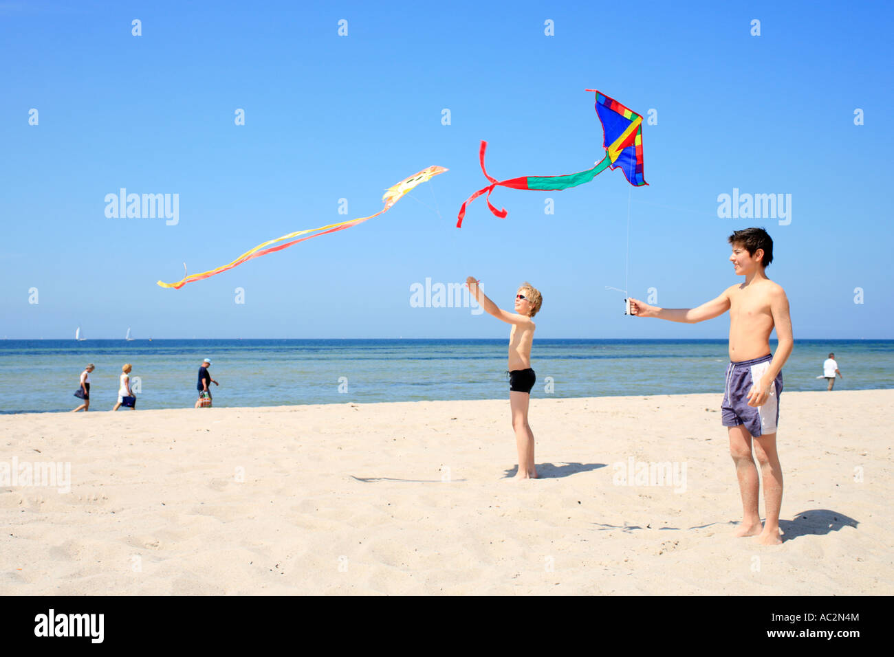 two young boys flying kites Stock Photo Alamy