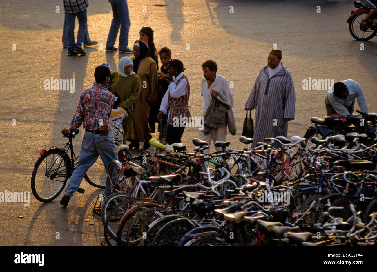 Morocco marrakech djemaa el fna plaza people walking near parked bikes Stock Photo