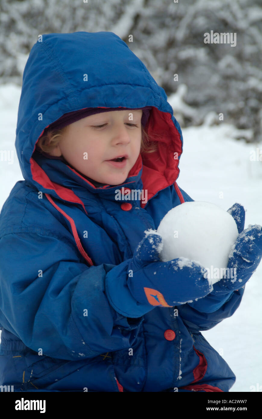 France french alps a three years old girl making a snow ball
