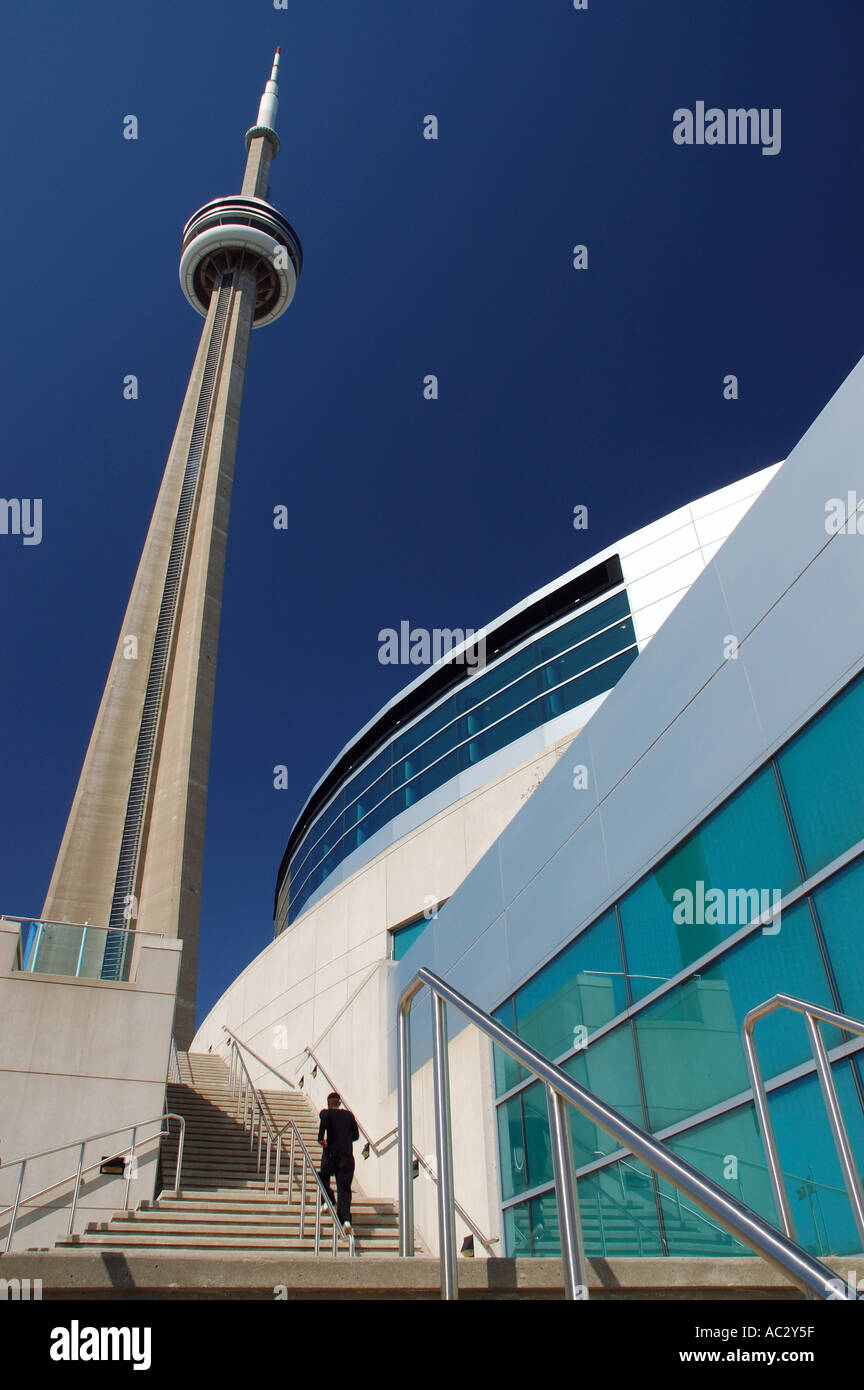 Man running up stairs at Toronto Convention Centre towars the CN Tower Stock Photo