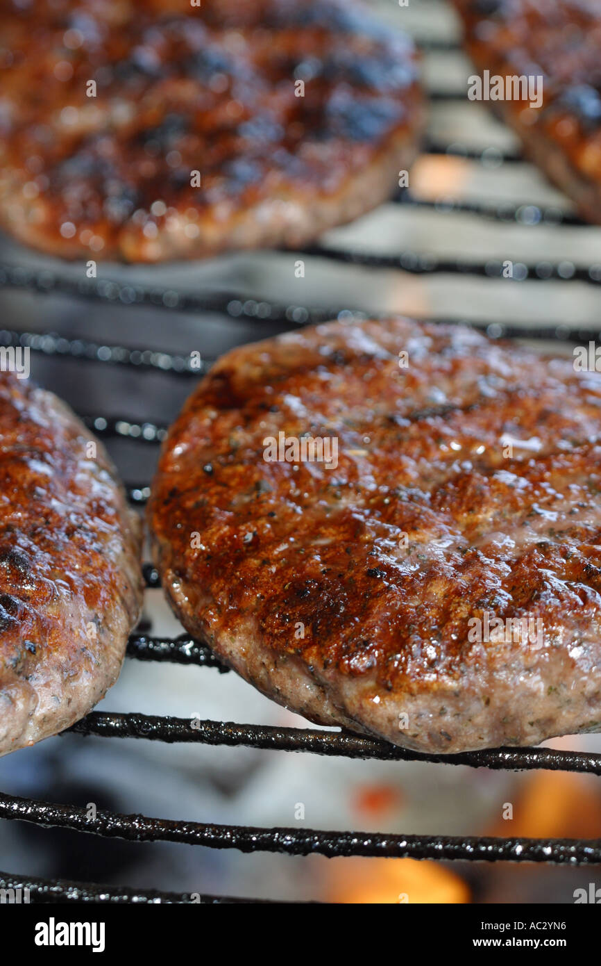 Barbecue BBQ grill cooking hamburgers meat burger flame Stock Photo - Alamy