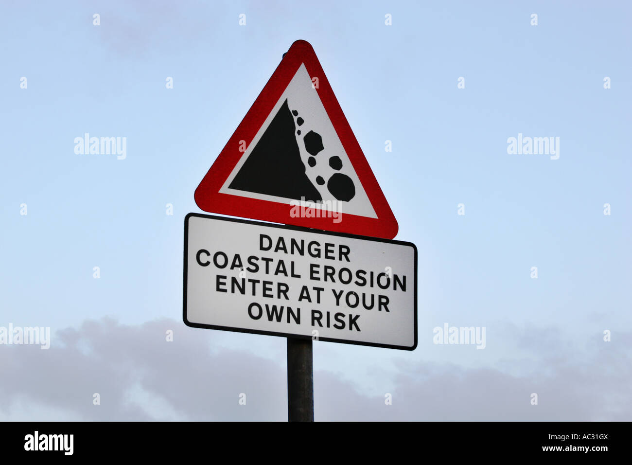 Danger sign for falling cliffs due to coastal erosion Stock Photo Alamy