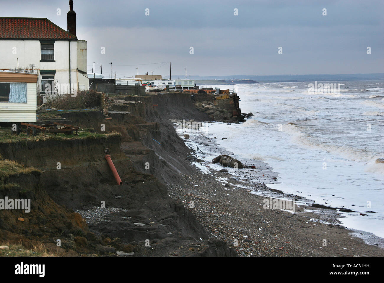 House very close to cliff top and in danger of falling into the sea. Stock Photo