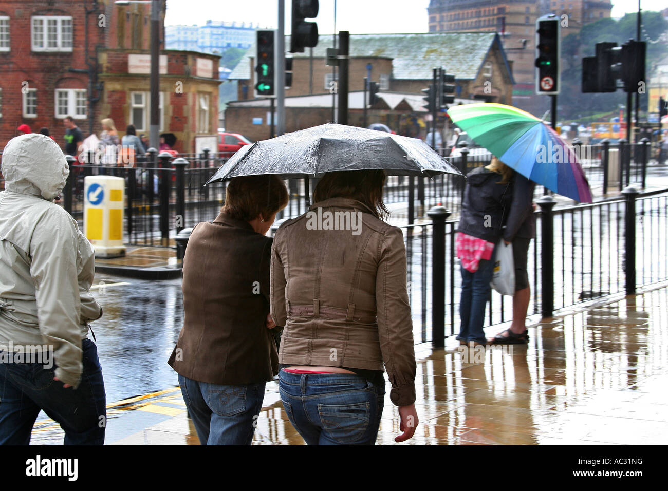 Multi coloured umbrella protecting people from heavy rain Stock Photo ...