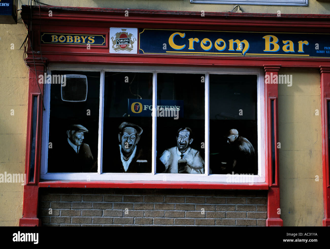 painted characters adorn the windows of one of irelands rural pubs Stock Photo
