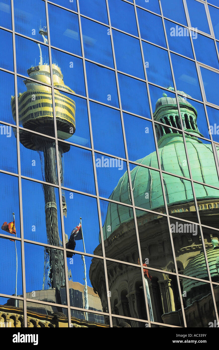 Sydney Tower and Queen Victoria Building mirroring in a glass facade