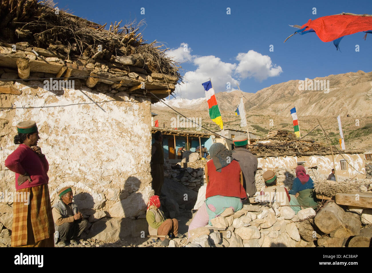 India Himachal Pradesh Spiti Nako village 2950m group of local villagers sitting in village street and talking Stock Photo