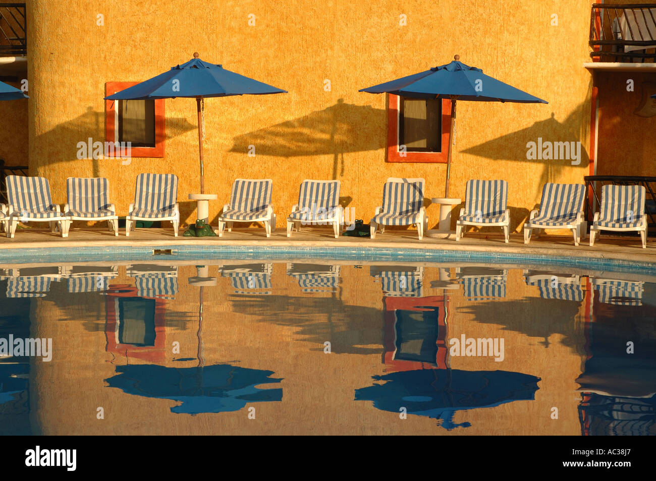 Chairs And Umbrellas Reflect In The Pool At Reef Playacar In