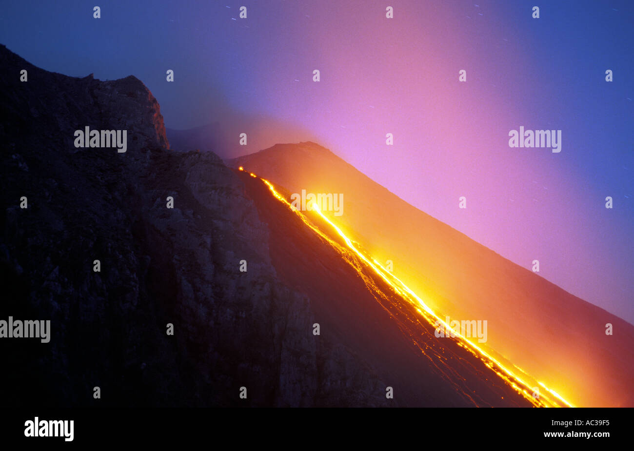 Lava flows from Stromboli volcano at night Stock Photo