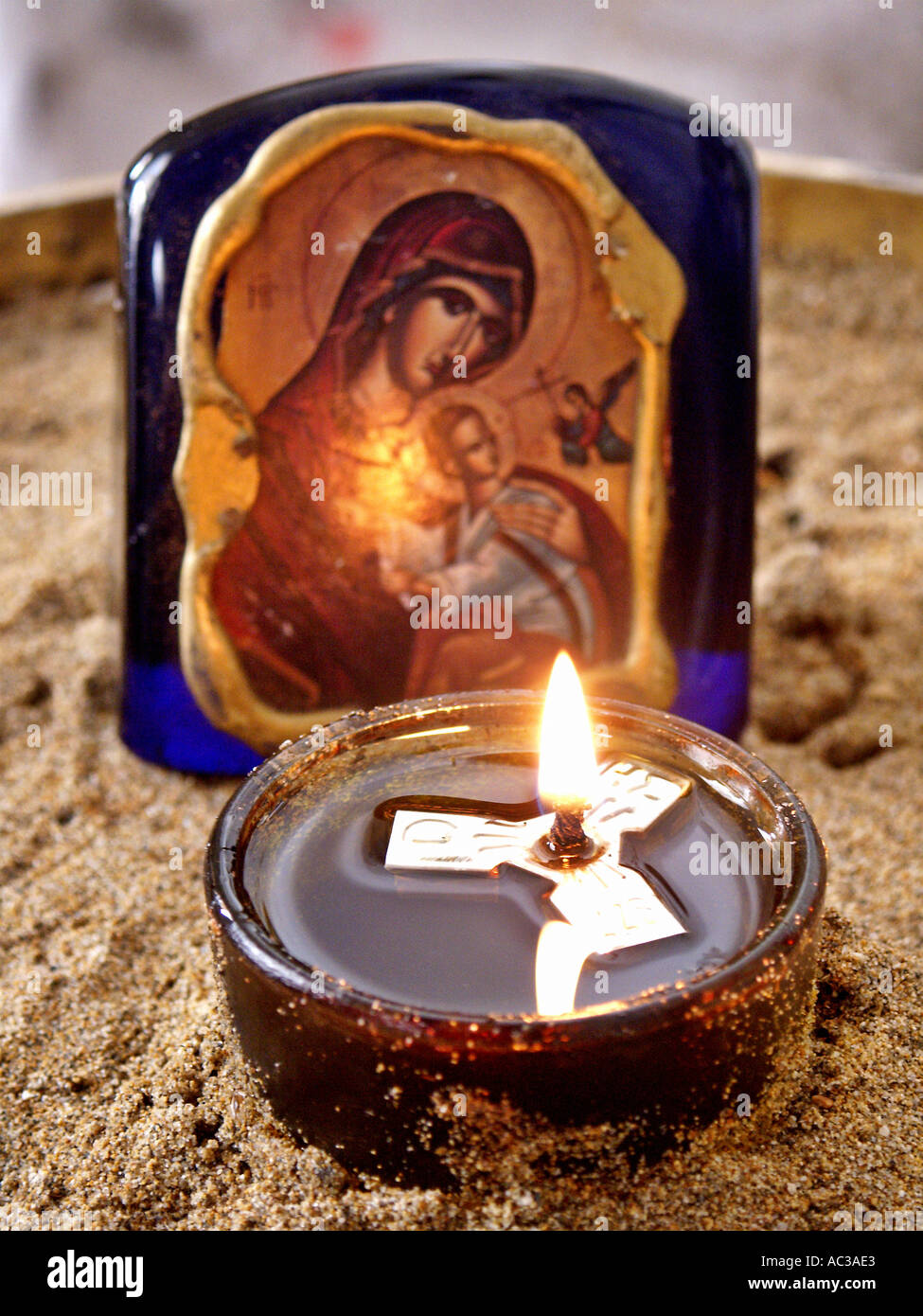 Bowl with oil and floating candle image of Virgin Mary holding small