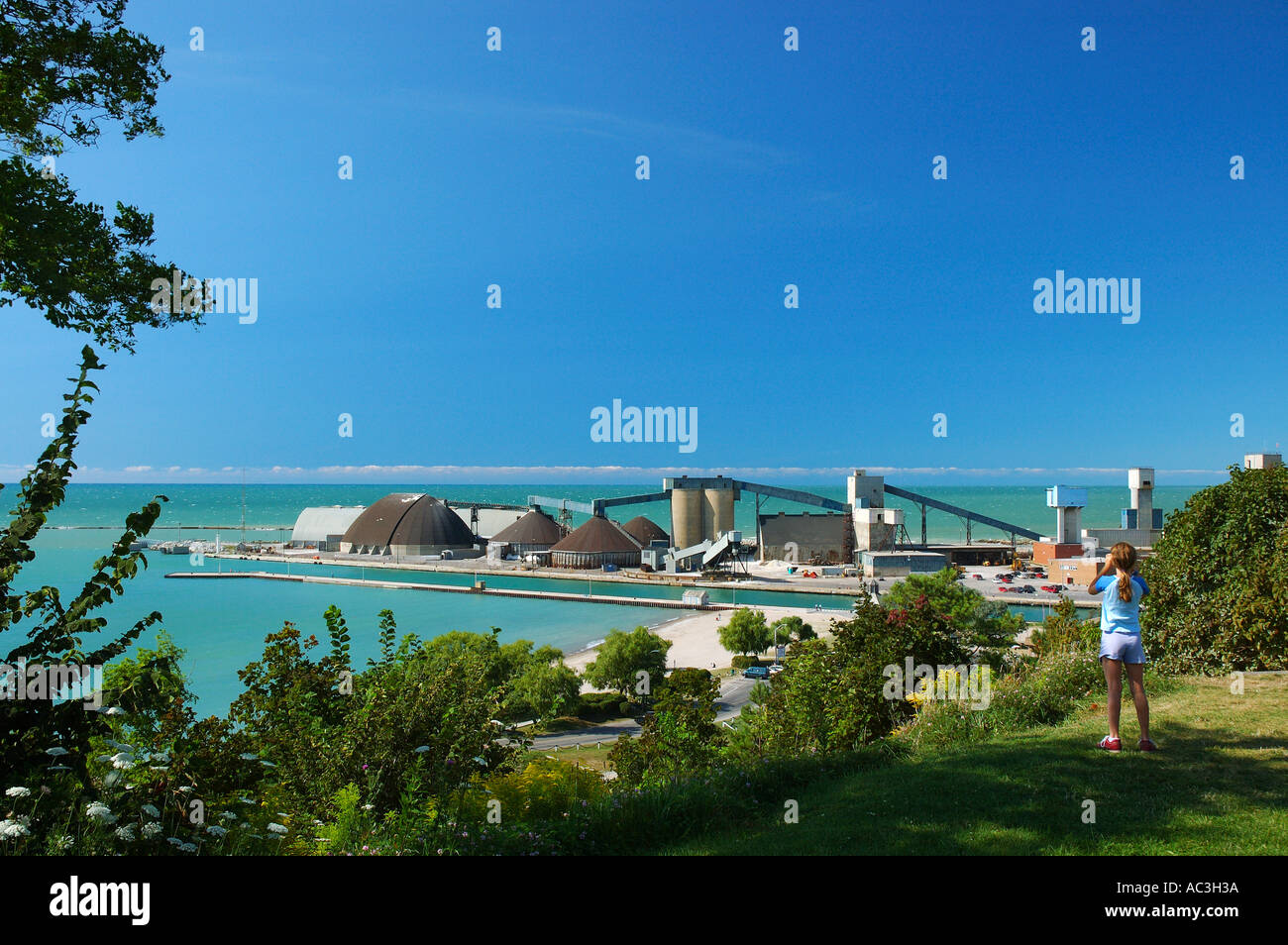 Girl viewing the Goderich Ontario salt mine plant on Lake Huron with