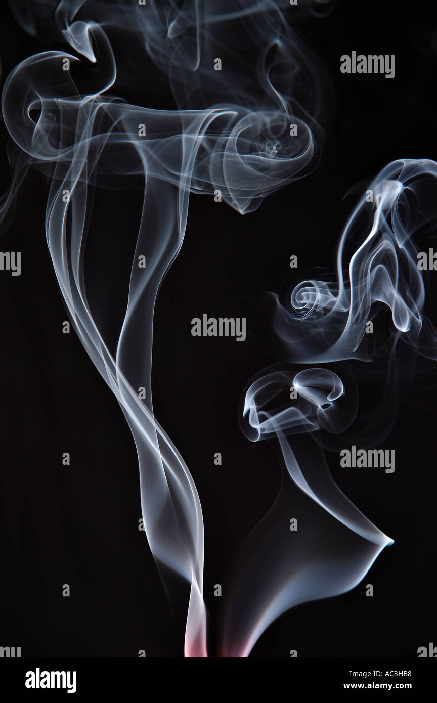 Shafts of curling smoke from extinguished candles or smoldering cigarettes Stock Photo Alamy