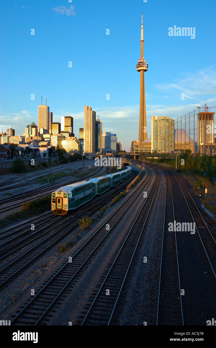 Toronto commuter GO train leaving the city after work with CN Tower Stock Photo