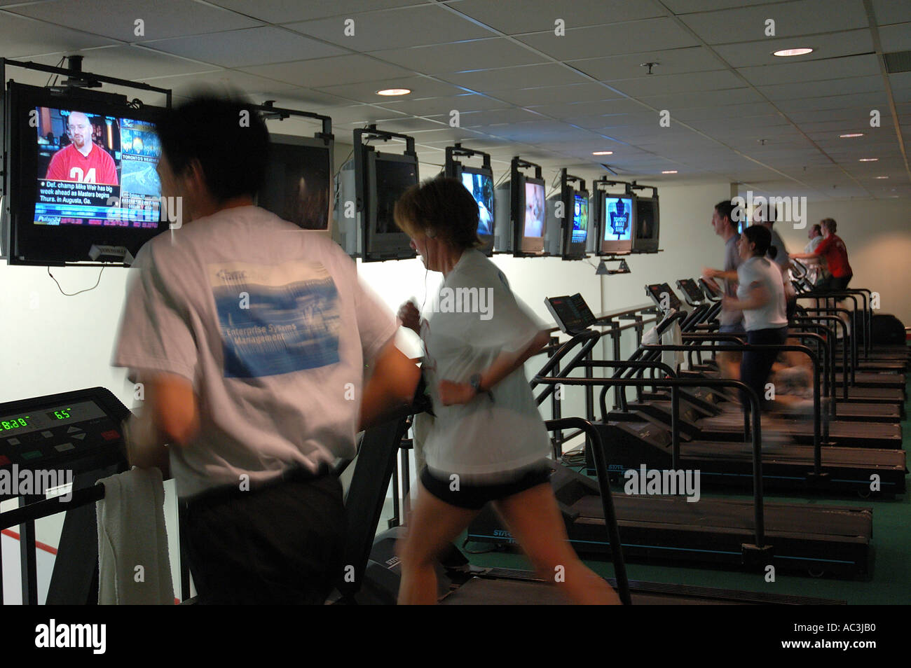 Running indoors on Treadmills while watching TV at gym in Toronto