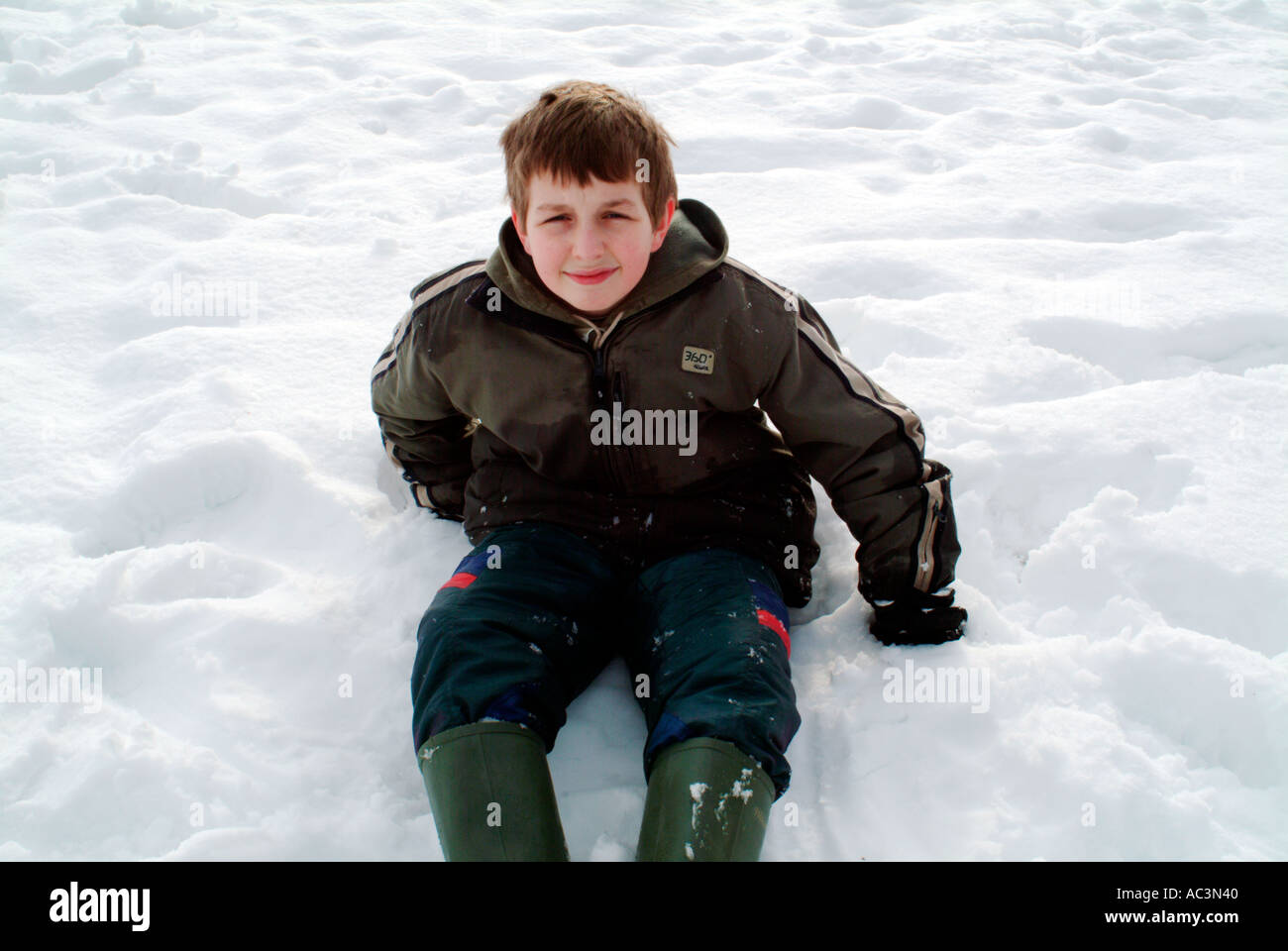 Happy child playing snow flakes hi-res stock photography and 