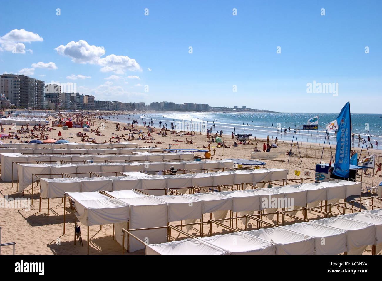 abundance of beach tent and people on a white sandy beach sun tanning and enjoying themselves sables d olonne france beach Stock Photo