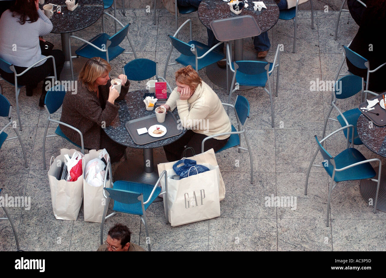 PHOTOGRAPH BY HOWARD BARLOW TIRED SHOPPERS STOP FOR A COFFEE at Manchester s Trafford Centre Stock Photo