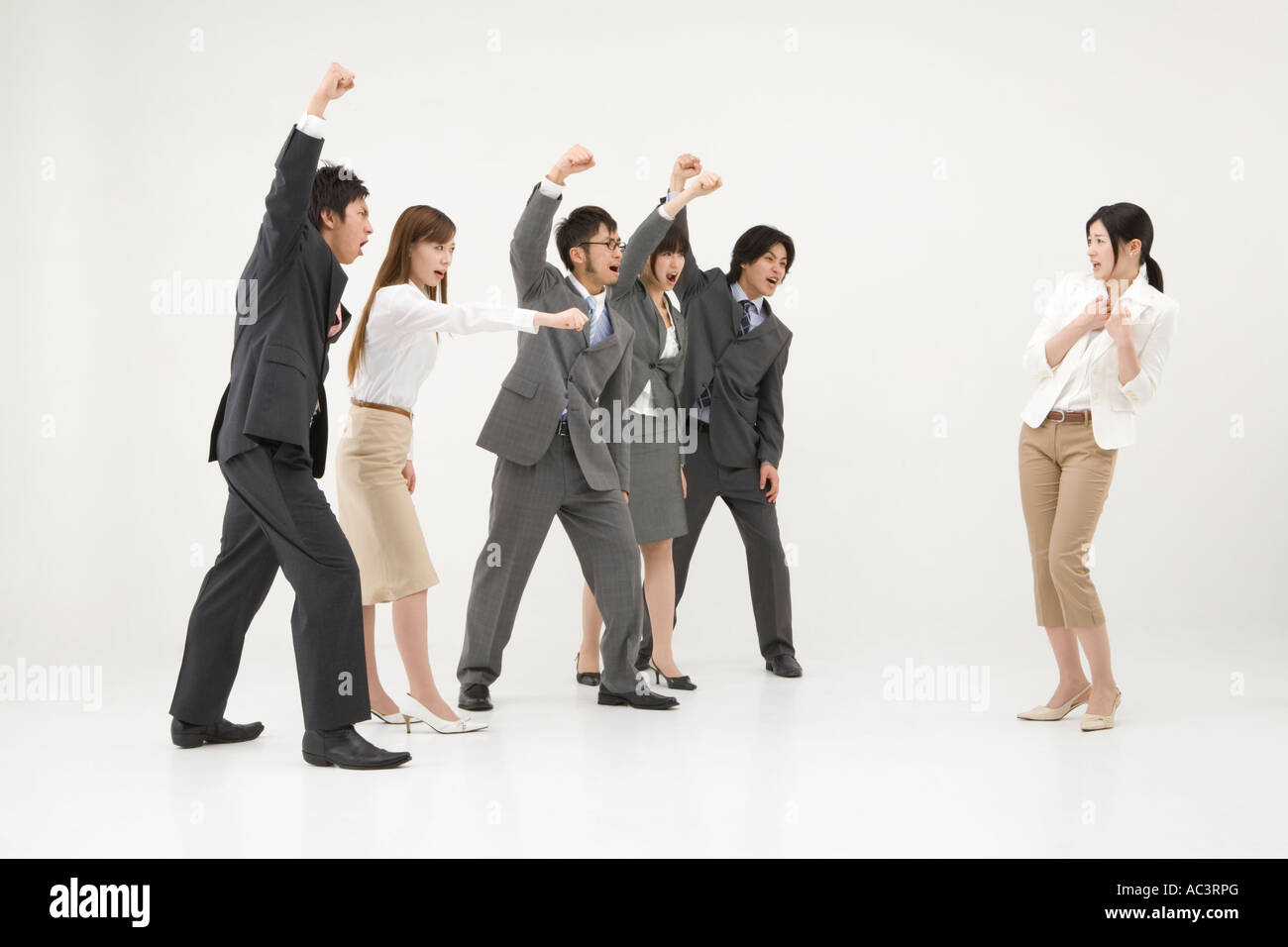 Group of business people shouting at colleague Stock Photo