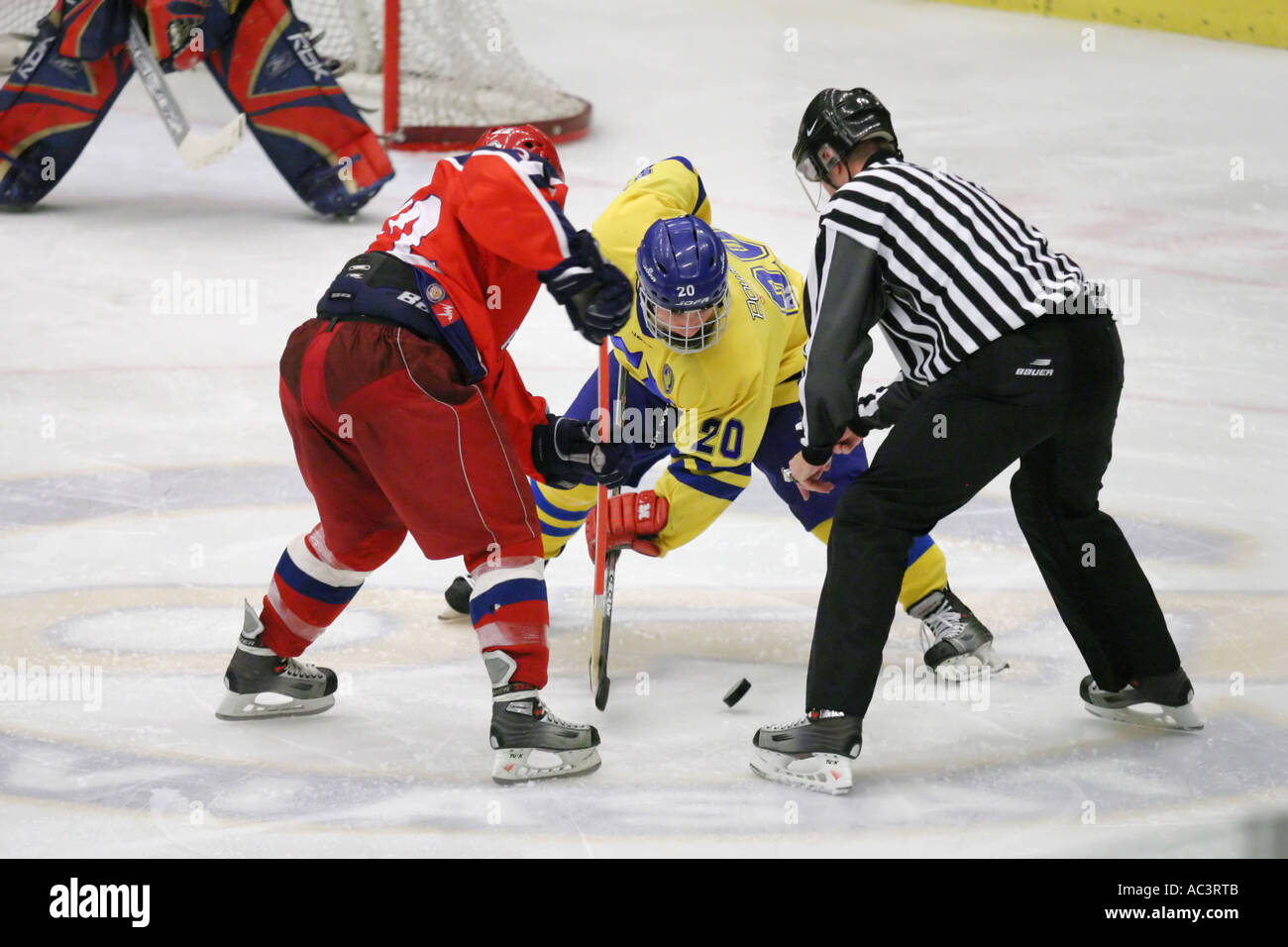 Face off at an ice hockey game between team Sweden and team Russia in