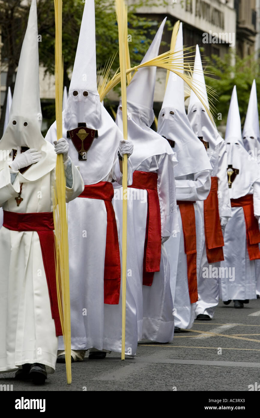 Hooded penitents carry palm fronds during Holy Week procession, Bilbao ...