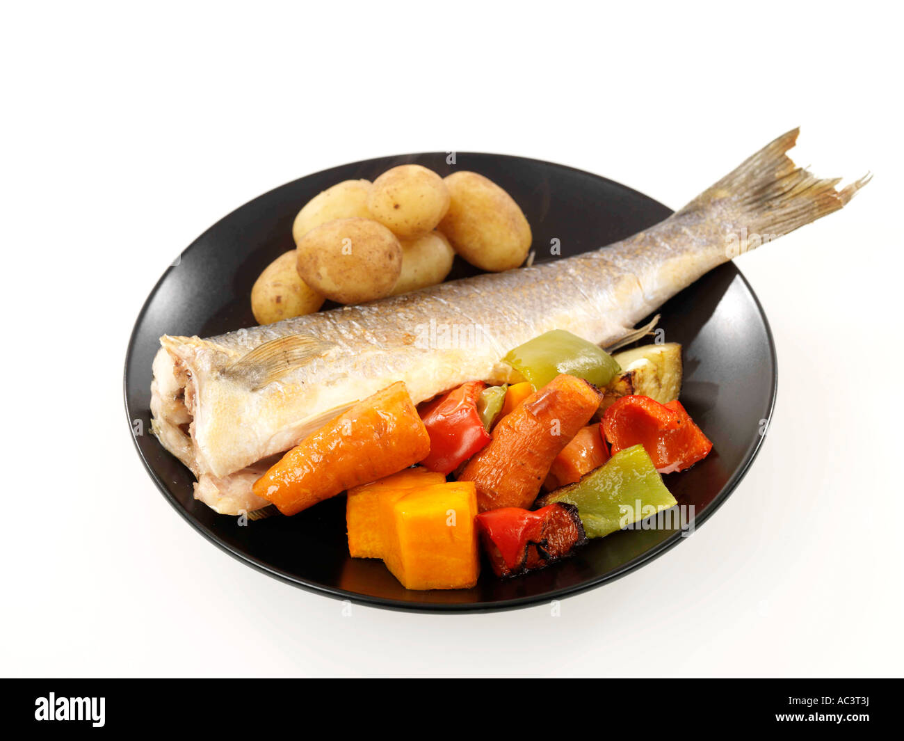 Baked Sea Bass With Roast Vegetables And New Potatoes Stock Photo Alamy