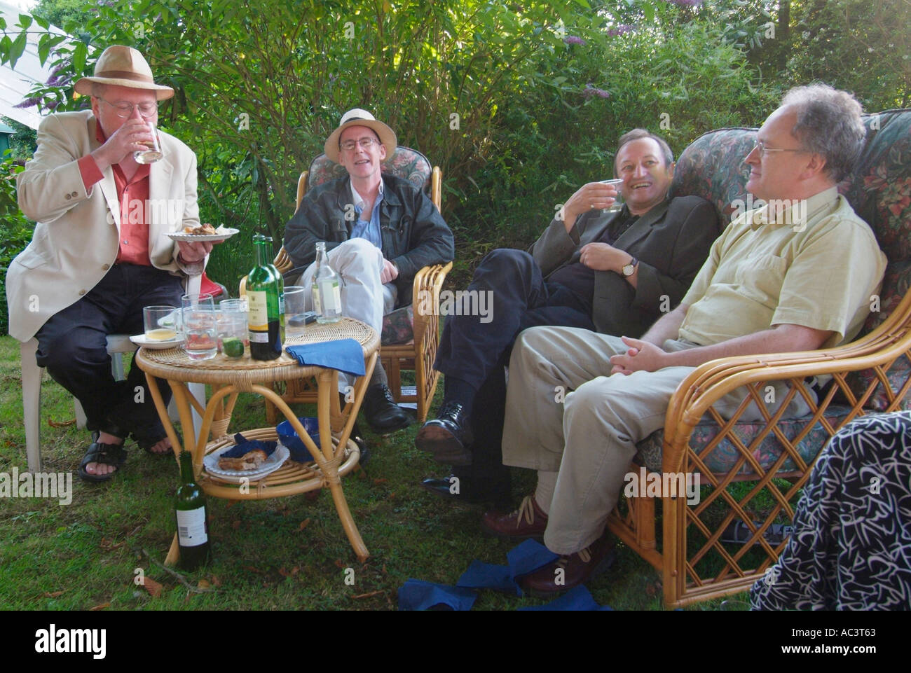 Middle aged group male men garden party grumpy old discuss talk converse  communicate repartee character conversation Stock Photo - Alamy