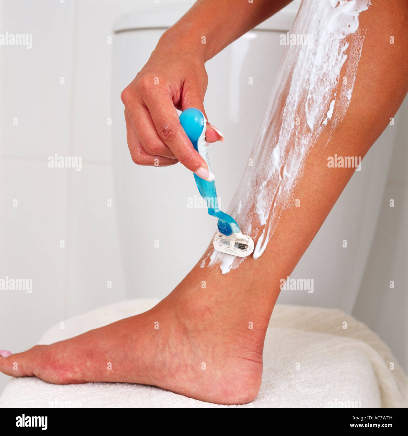 Young Woman Shaving Legs With A Razor In A Bathroom Stock Photo Alamy