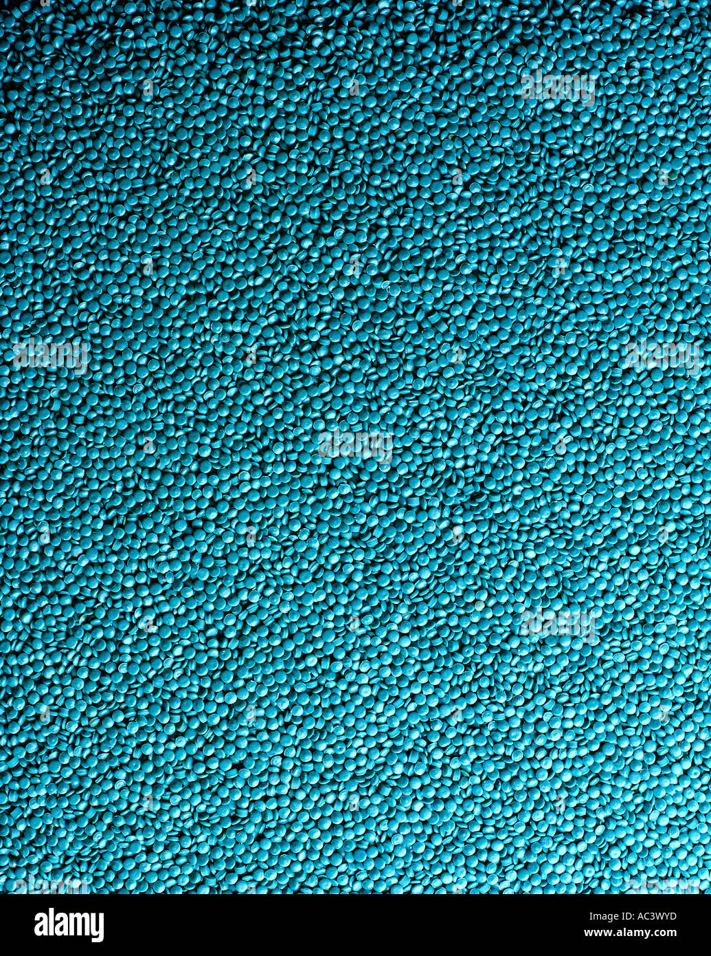 BLUE PLASTIC BEADS RAW MATERIAL FOR INJECTION MOULDING MACHINES Stock Photo