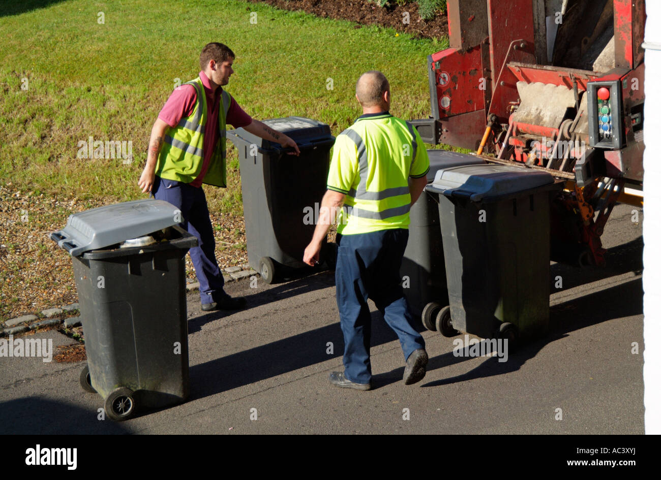 Wheelie bin Council refuse collection bins being emptied onto dustcart SERCO employees Stock