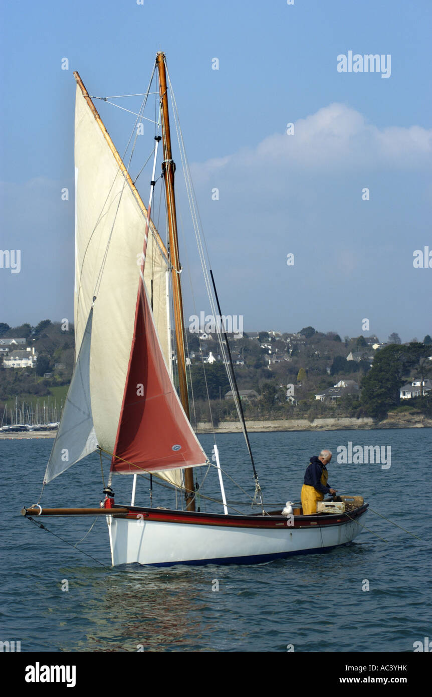 A traditional oyster dredger sailing boat at work in Carrick Roads in