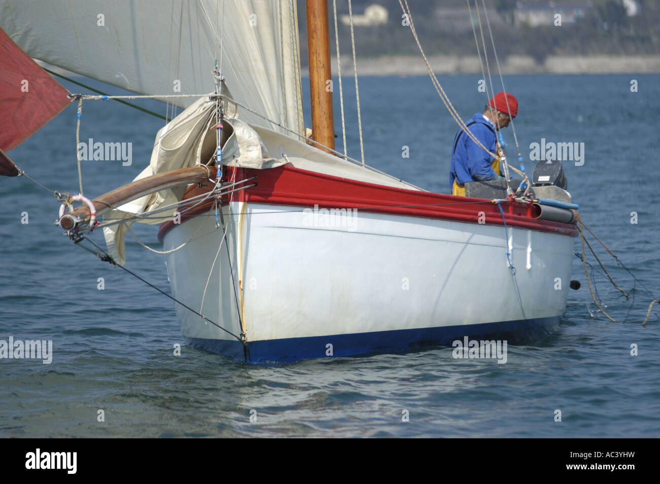 A traditional oyster dredger sailing boat at work in Carrick Roads in