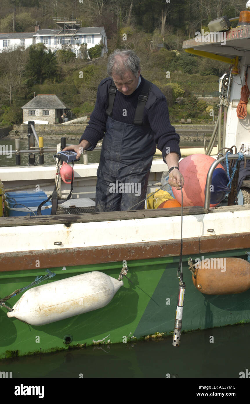 Falmouth Port Health Officer taking water quality sample on the River Fal Cornwall Stock Photo
