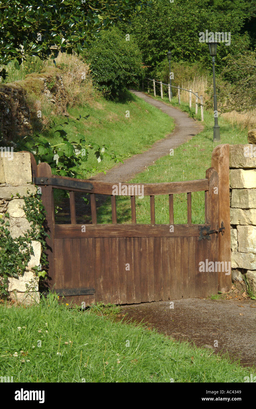 Wooden gate leading along path Compton Abdale Gloucestershire Cotswolds