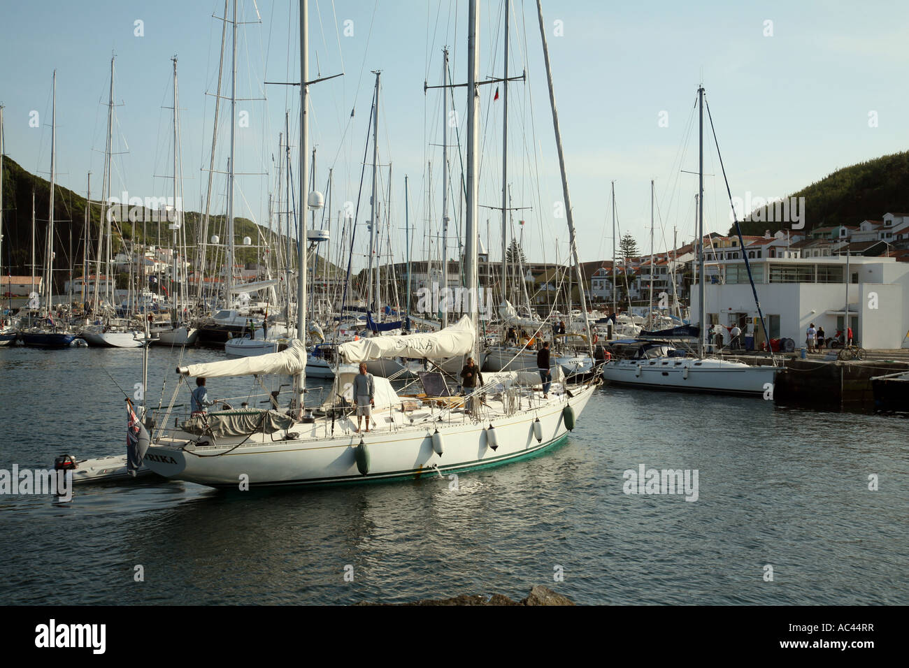 A sailing yacht sails into Horta Harbour marina, Faial, The Azores
