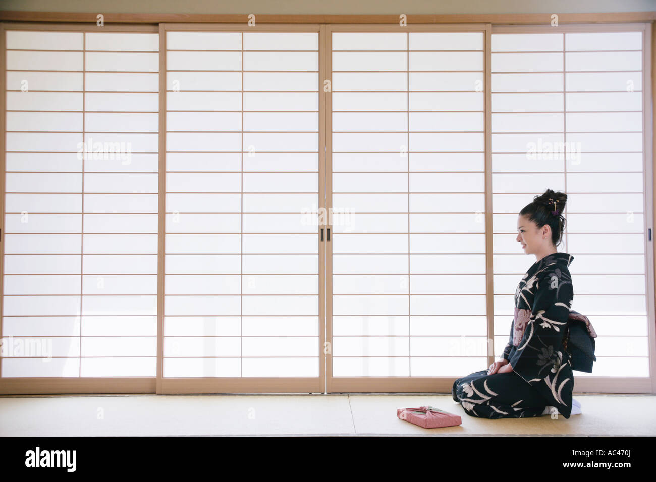 Young woman in kimono sitting on floor Stock Photo Alamy
