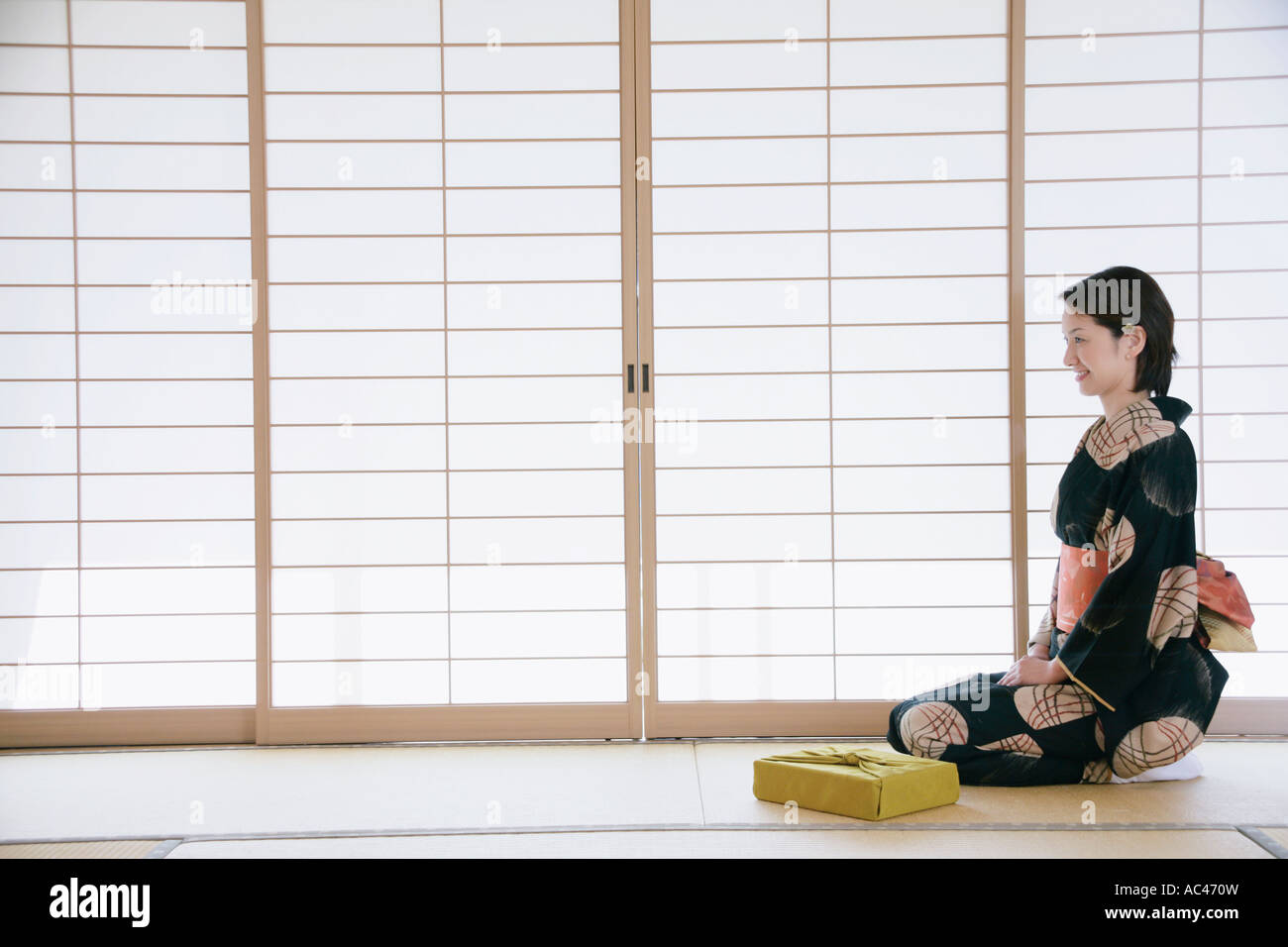 Young woman in kimono sitting on floor Stock Photo Alamy