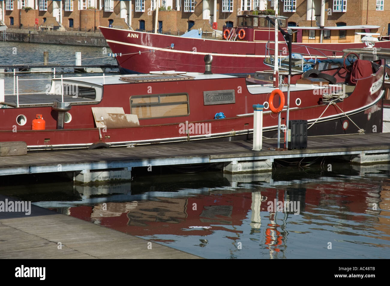 Red boats in Greenland Dock, Rotherhithe, London, England, UK Stock