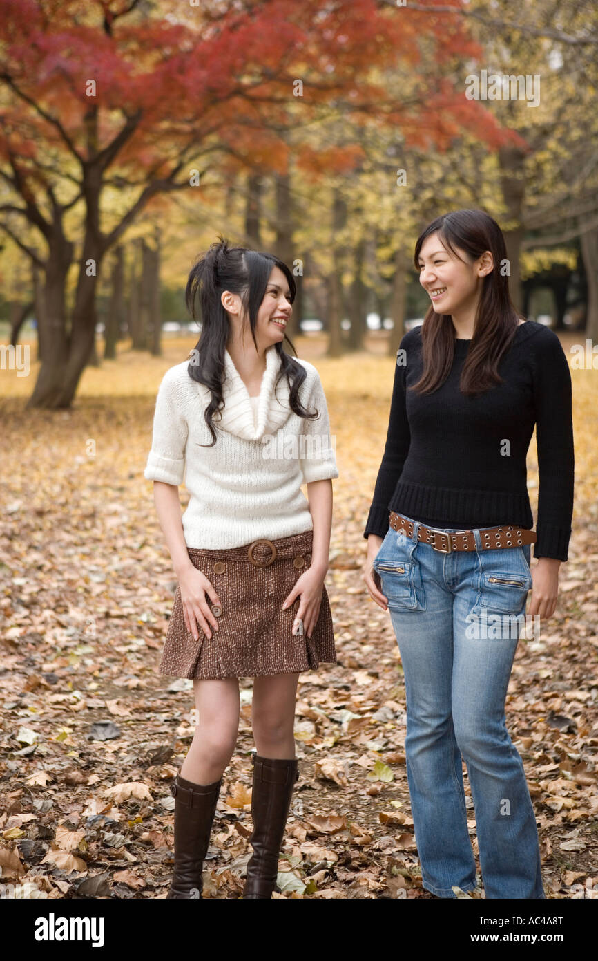 Two young women walking Stock Photo - Alamy