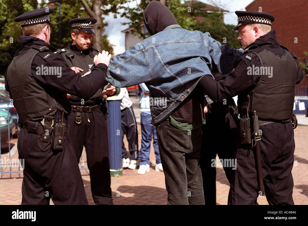 Young demonstrator being searched by police under section 44 at an arms trade demonstration in London. Stock Photo