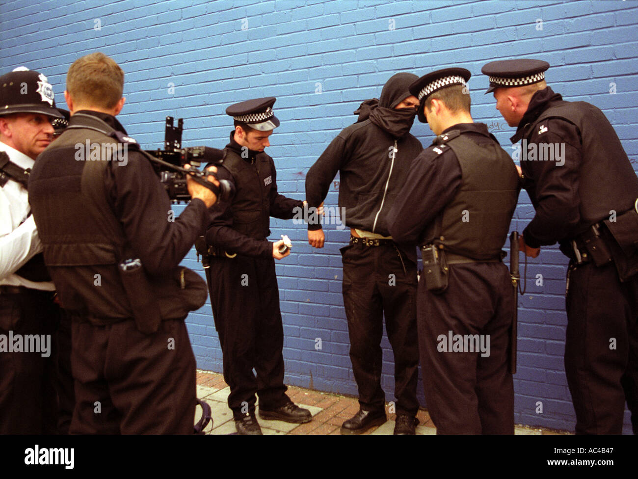 Young demonstrator being searched by police under section 44 at an arms trade demonstration in London. Stock Photo