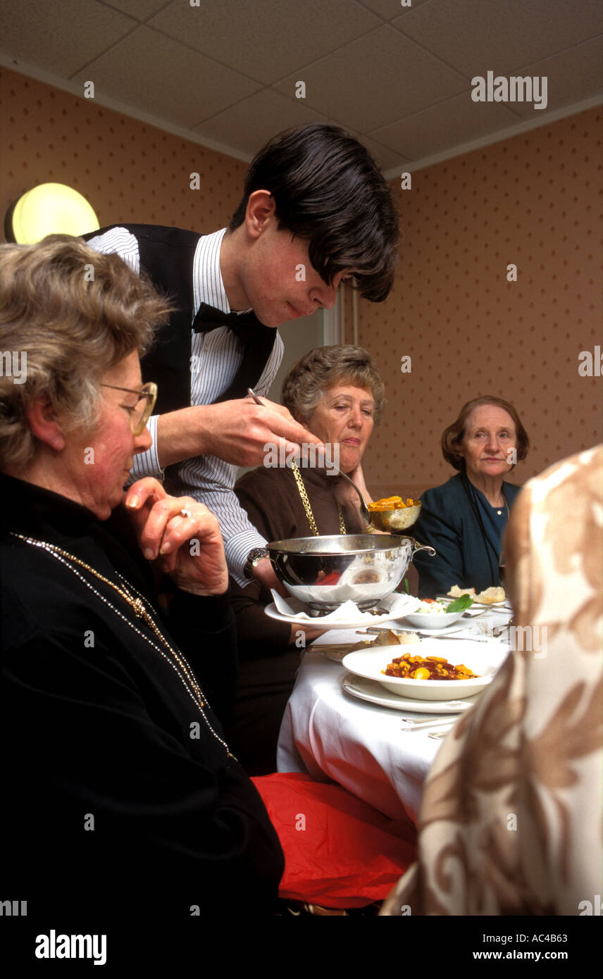 Young student waiter serving lunch Stock Photo