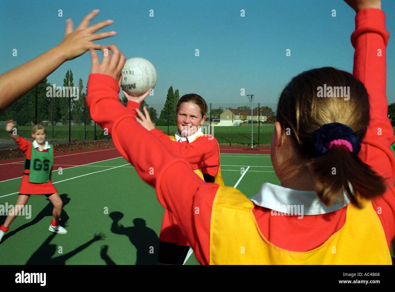 Females playinGBasket netball at a secondary school Stock Photo