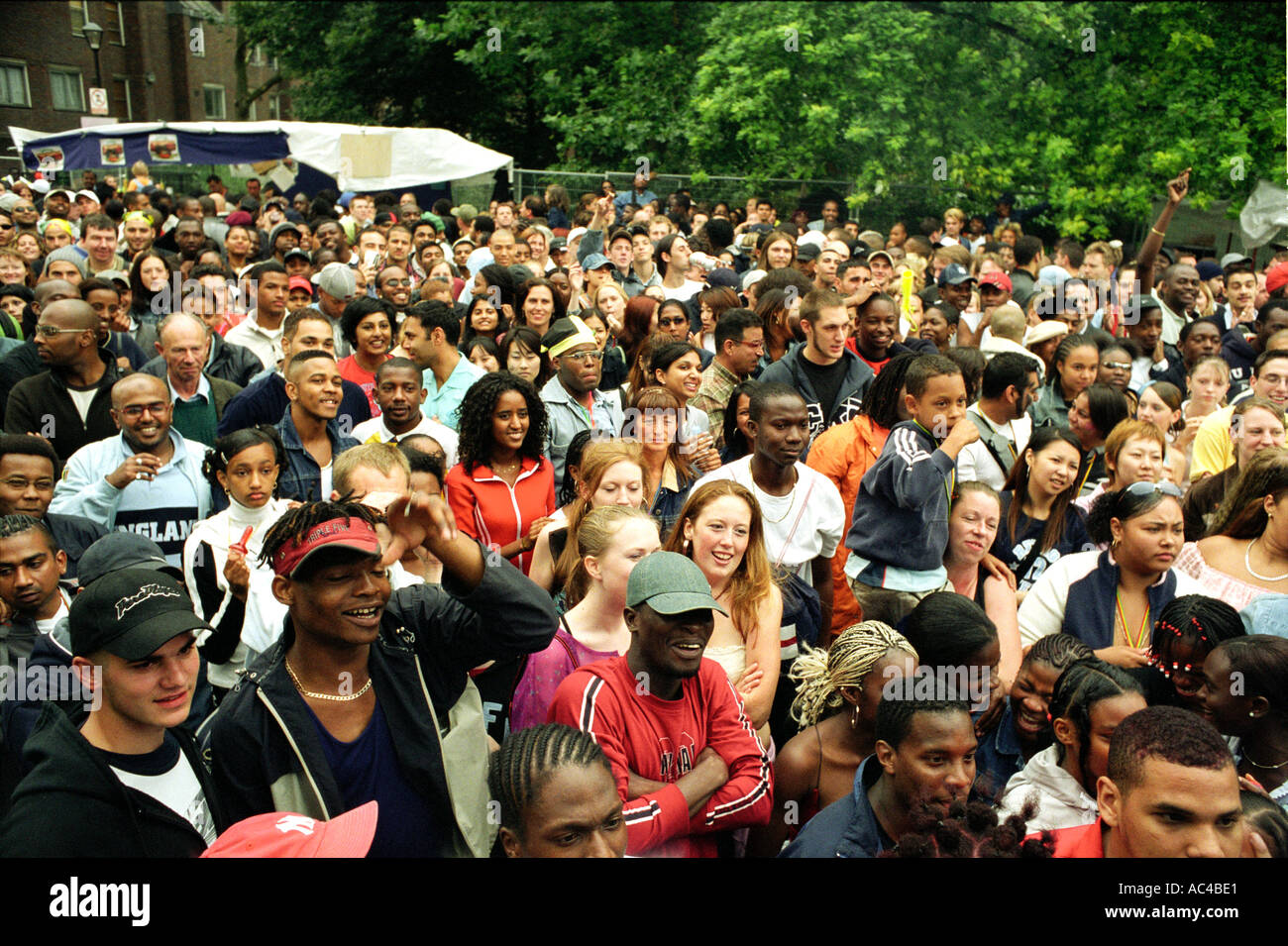 Large crowd listening to street band in a side street at Notting Hill Gate carnival. Stock Photo
