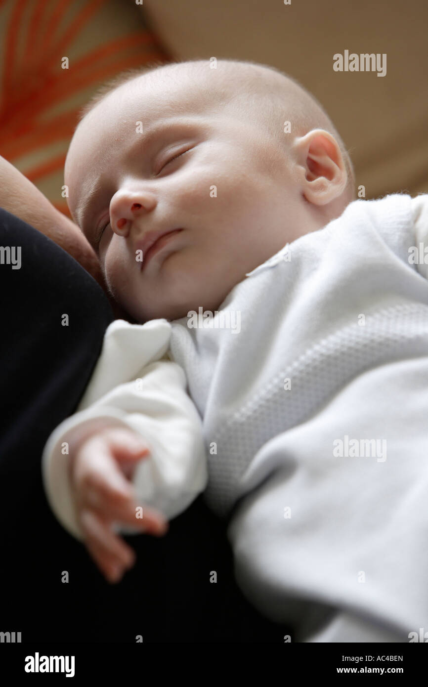 Sleeping baby in mother's arms Stock Photo Alamy