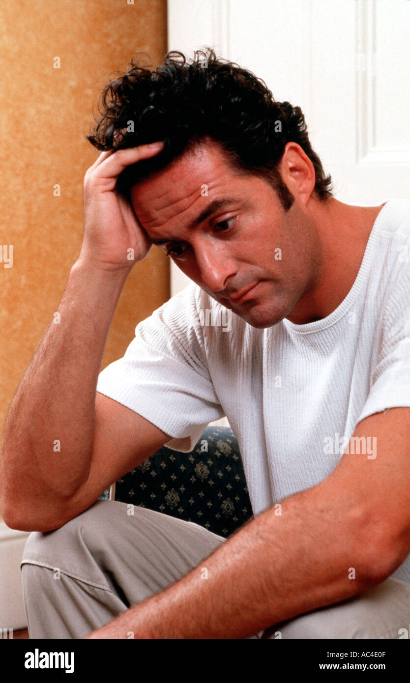 W 18126 63 Model Released Male sitting with hand on head Henry Arden RBO Stock Photo
