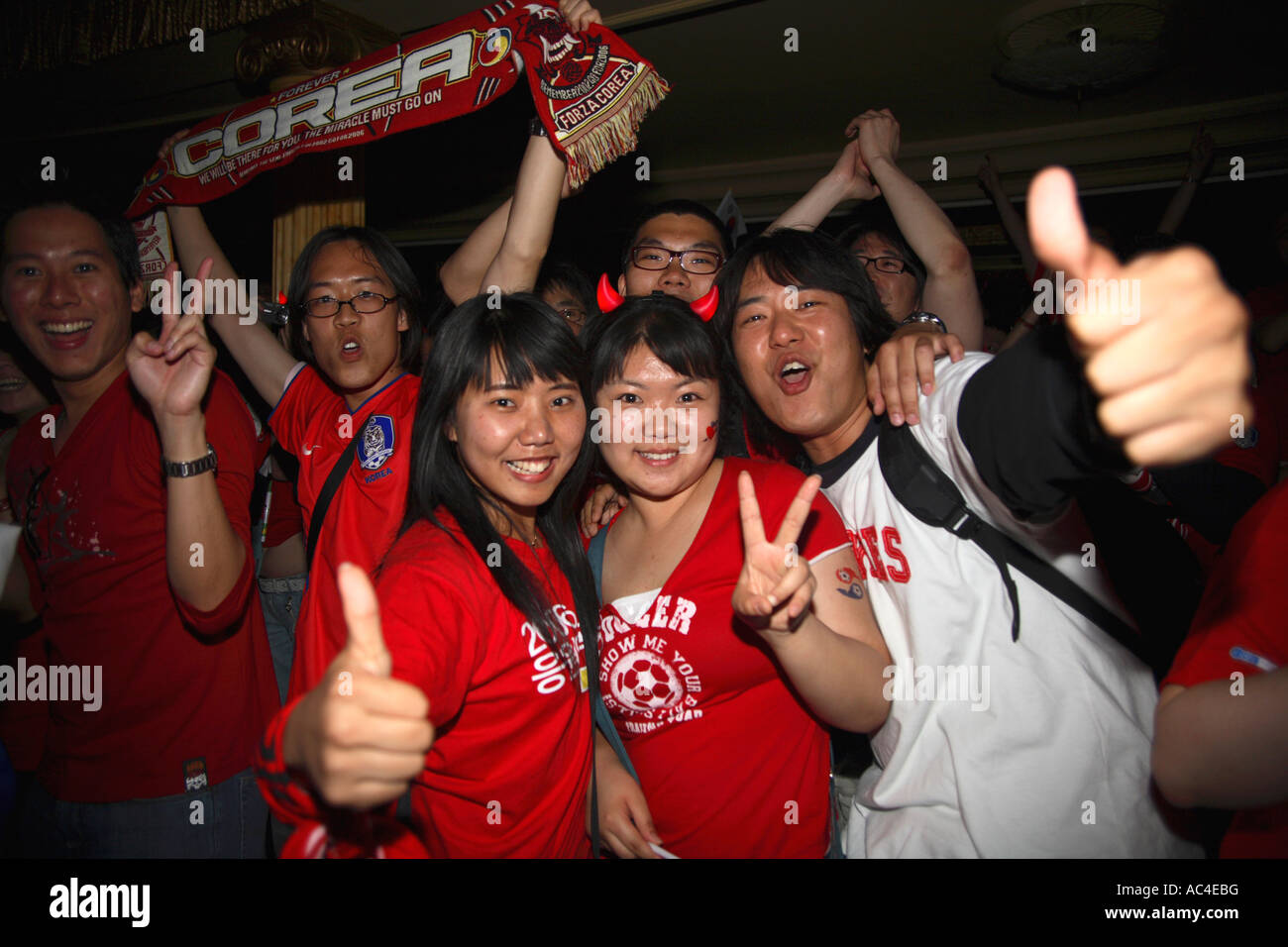 South Korean (Republic) fans celebrating after 2006 World Cup Finals drawn match vs France, Cafe de Paris, London Stock Photo