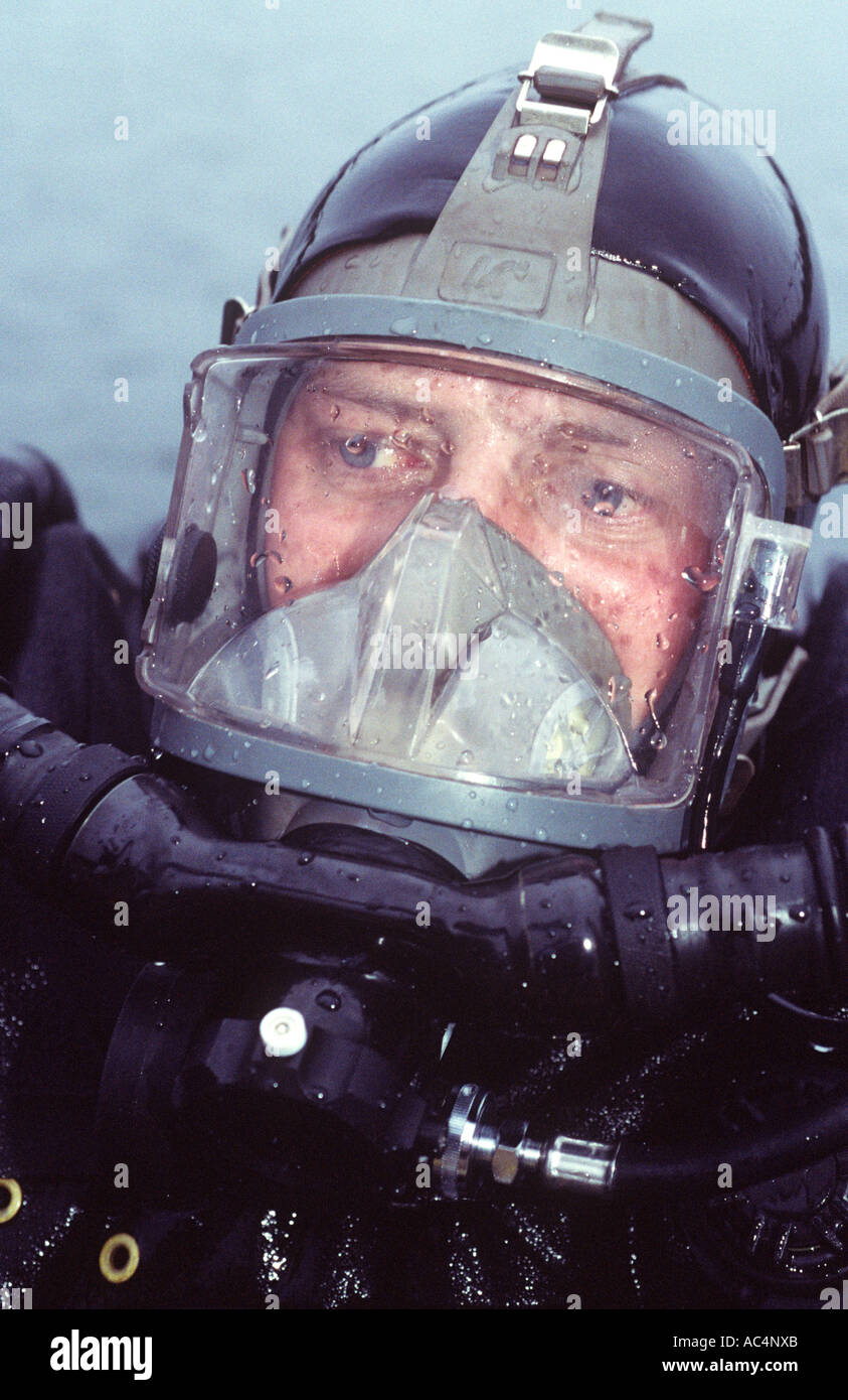 Military EOD diver wearing full face mask with built in communications and using a rebreather