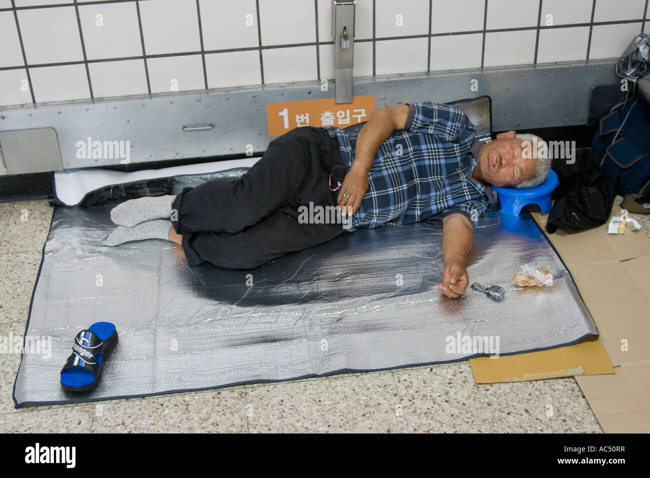Middle Aged Homeless Man Sleeping in the Subway Seoul South Korea Stock Photo